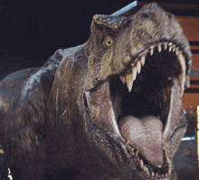 a close up of a dinosaur 's mouth with its tongue hanging out