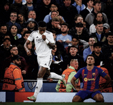 a soccer player wearing a fly emirates jersey celebrates