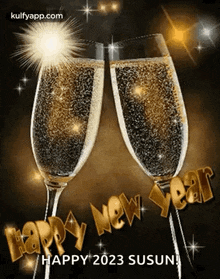 two glasses of champagne with the words `` happy new year '' written on them .