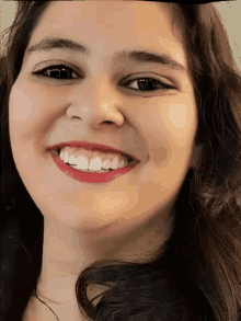 a close up of a woman 's face smiling