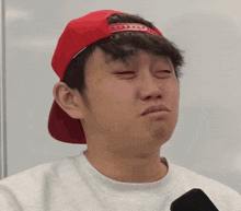 a man wearing a red hat and a white sweater says money can 't buy