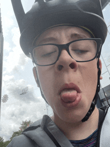 a person wearing a helmet and glasses making a face