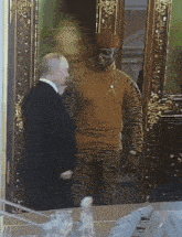 a man in a suit and a man in a military uniform are standing next to each other