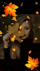 a woman is holding a leaf in front of her face