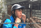 a man wearing a helmet and a blue shirt with the words nha minh thi cach truong khoang nam 6 cay written below him