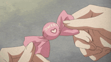 a person is holding a piece of pink paper with a red circle in the middle