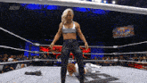 a woman in a wrestling ring with a sign that says aew in the background