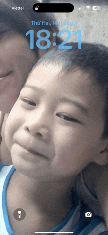 a phone screen with a picture of a child and the time 18:21