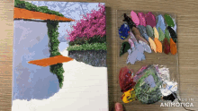 a painting on a canvas next to a palette with the words made in animatica on the bottom