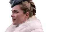 a woman wearing a fur coat and a hat looks to the side