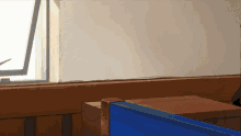 a room with a window and a blue box on the floor