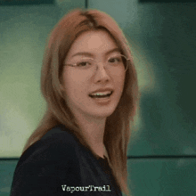 a close up of a woman wearing glasses and a black shirt