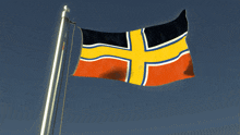 a flag with a cross on it is flying in the wind