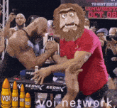 two men arm wrestling in front of a sign that says ' to host 2021 '