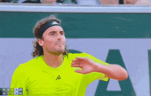 a tennis player wearing a headband and a neon yellow shirt with the number 40 on it