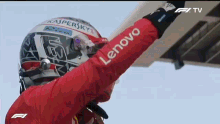 a man wearing a red jacket with lenovo written on the sleeve