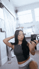 a woman is taking a selfie in a mirror