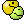 a pixel art of a pac man and a green ghost .
