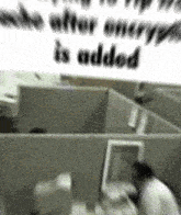a blurry picture of a man in a cubicle with the words " who after encrypt is added "