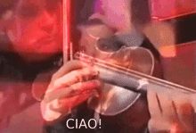 a person is playing a violin with the words ciao written below it