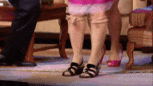 a woman is wearing a pair of black sandals
