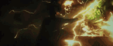 a person is being hit by a lightning bolt in the dark .