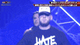 a man wearing a black shirt that says latte walks on a stage