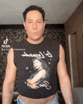 a man is wearing a crop top with a picture of selena quintana