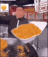 a man is holding a styrofoam container full of food in front of a sign that says support your local chinese restaurant