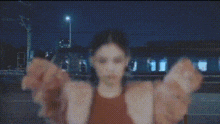 a woman in a red top and blue wings is standing in a dark room .