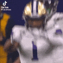 a close up of a football player wearing a helmet with the number 1 on it