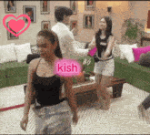 a woman in a black top has the word kish on her arm