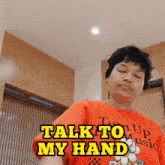 a man in an orange shirt says talk to my hand