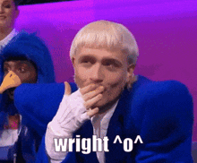 a man in a blue suit is covering his mouth with his hand and the word wright is on the bottom right