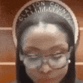 a woman wearing glasses and a clayton county headband