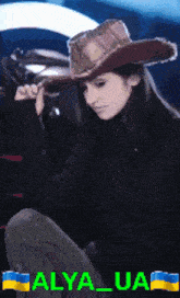 a woman wearing a cowboy hat has the name alya_ua on the bottom right