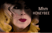 a close up of a woman 's face and the words mhm honeybee