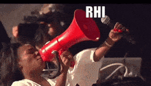 a woman is holding a red megaphone and the word rhi is on it