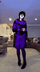 a person in a purple outfit is standing in a living room with a viggle.ai logo