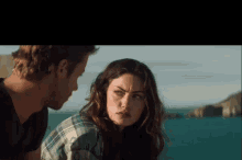 a man and a woman are looking at each other