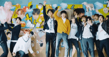 a group of young men are posing for a picture in front of a wall with stickers on it