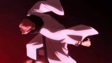 a man in a white robe is standing in a dark room .