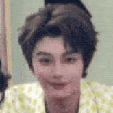a close up of a person 's face with a blurred background making a funny face .