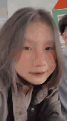 a close up of a girl taking a selfie with a man .