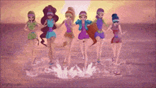 a group of girls standing on a beach holding hands .