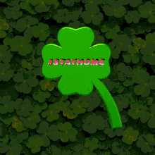 a green whistle is sitting in front of a wall of clovers