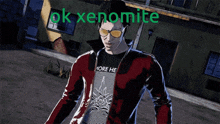 a man wearing sunglasses and a shirt that says more he is standing in front of a building that says ok xenomite