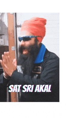 a man with a beard wearing sunglasses and a red hat with the words sat sri akal below him