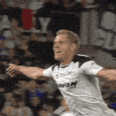 a soccer player wearing a white shirt with avon written on it