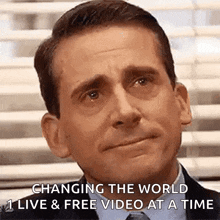 a man in a suit and tie is crying and says `` changing the world live & free video at a time ''